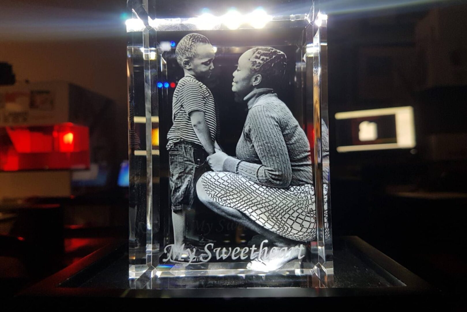 3D etched crystal of a woman and child embracing.