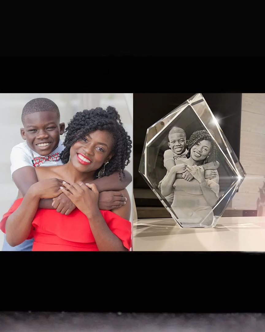 A joyful mother and son pose alongside a crystal family portrait.